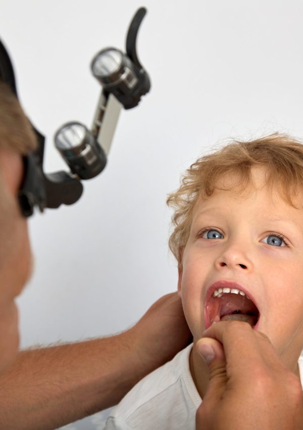 Experienced,Ent,Doctor,Carefully,Examines,Palatine,Tonsils,Of,Child,For