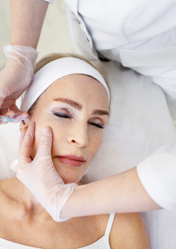 Senior,Woman,Receiving,Aesthetic,Facial,Injection,By,Professional,Cosmetologist,In